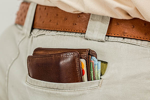 Wallet sticking out of pocket.